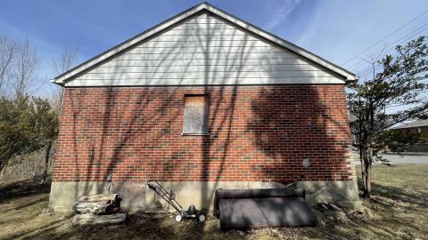 Tightly boarded up house photo 3