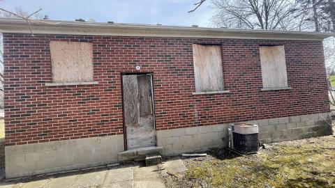 Tightly boarded up house photo 2