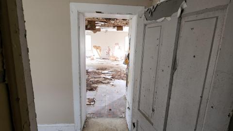 Bottom of stairs looking into kitchen