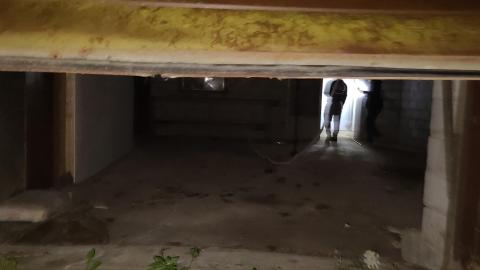 Open garage entryway door on front exterior of House 1