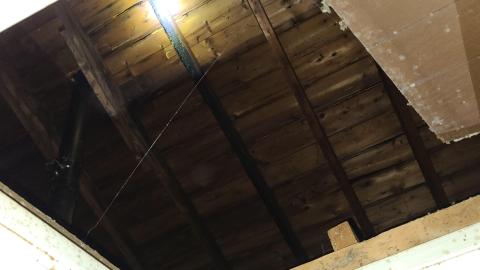 Open attic entryway on the ceiling of House 2
