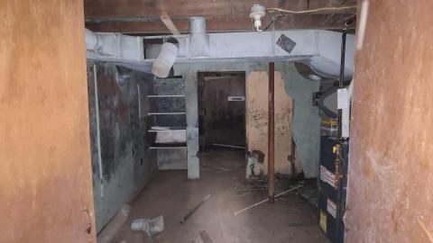 Furnace room inside the basement of House 5