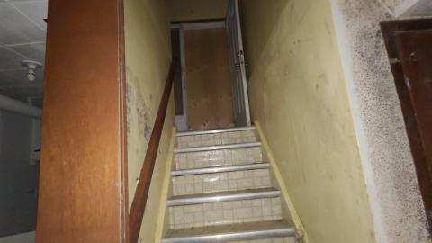 Stairway from the basement to the main floor of house 5