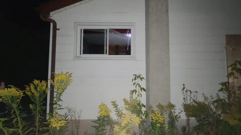 An open window at the rear exterior of House 5