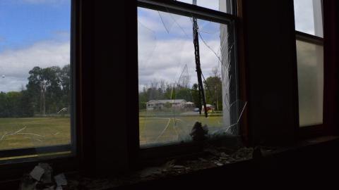 A view from the main classroom outside a smashed window.