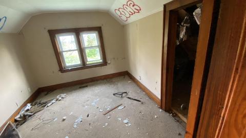 Bedroom upstairs with door to crawl space