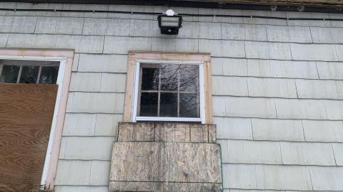 Half boarded up window