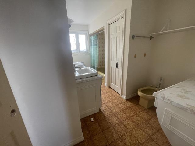 70s bungalow sits in a neighborhood of new mansions photo 4