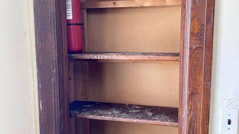 Shelf with a fire extinguisher on it