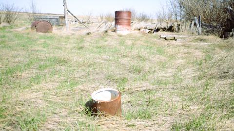Some barrels located near a farmyard