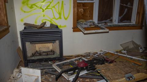 A broken fireplace and vacuum