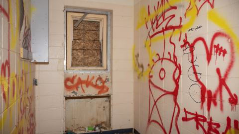 A room with a boarded window