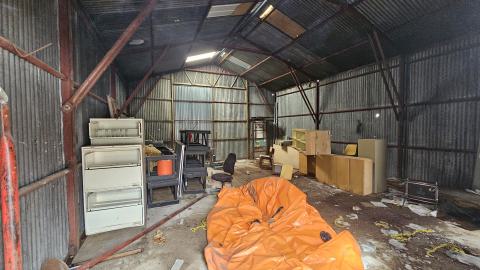THe interior of the warehouse with old desks and office furniture