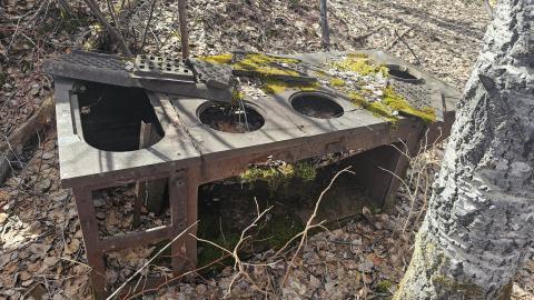 An old cook stove at the entrance of the cookhouse foundation