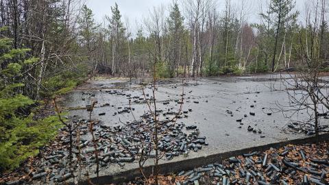 A concrete pad with old diamond drill core spilled