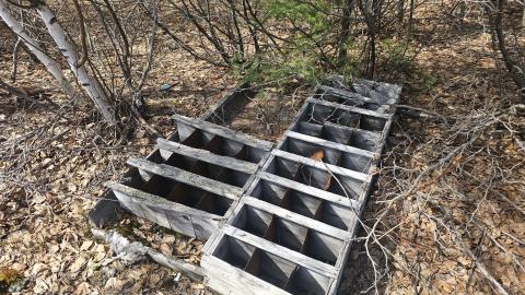 An old discarded shelf at the end of the concrete pad