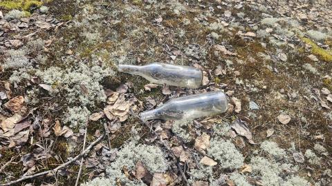 Discarded bottles near the car pyre