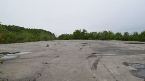 Giant concrete pad, train track goes along the left side on this photo. View is looking at the east.