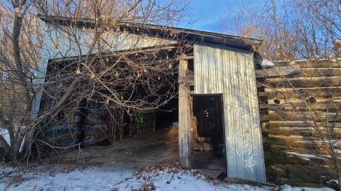 The large garage next to the barn has a few sectioned rooms.