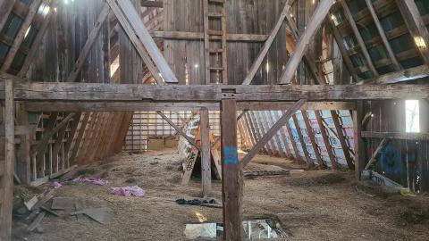 The second floor of the loft is filled with hay.