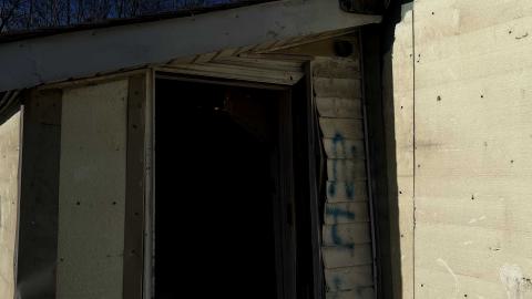 a back door of an abandoned house with no door