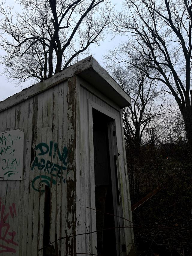 an abandoned shed with graffiti on it