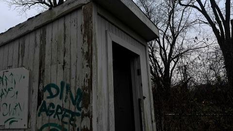 an abandoned shed with graffiti on it