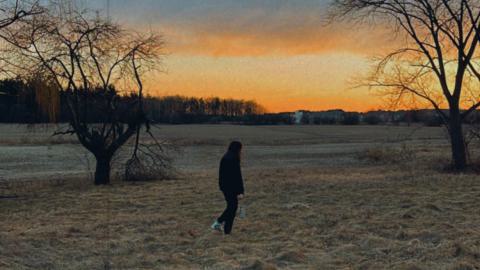 a man walking in a field