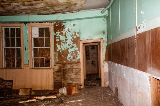 Abandoned classroom with equipment scattered throughout the floor.