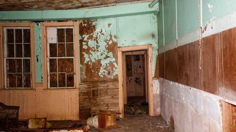 Abandoned classroom with equipment scattered throughout the floor.