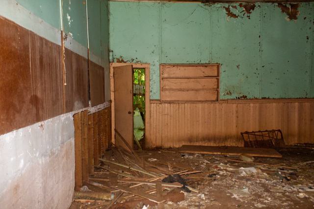 Broken wood panels scattered on the classroom floor.