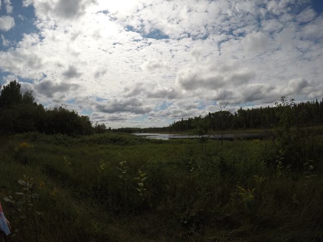 Looking at the lake, holiday homes are faintly seen in the distance.