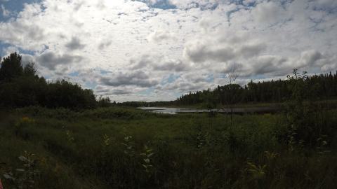 Looking at the lake, holiday homes are faintly seen in the distance.