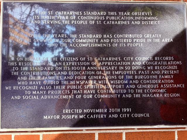 A plaque on the side of the building