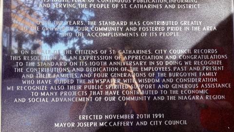 A plaque on the side of the building