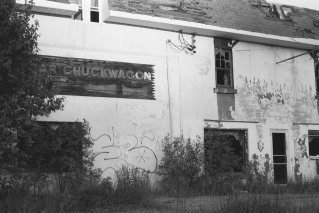 front of building with deteriorating sign