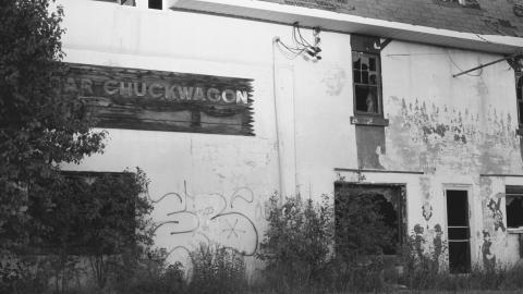 front of building with deteriorating sign