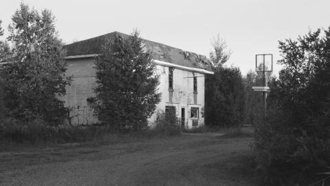 what's left of the road sign and entrance