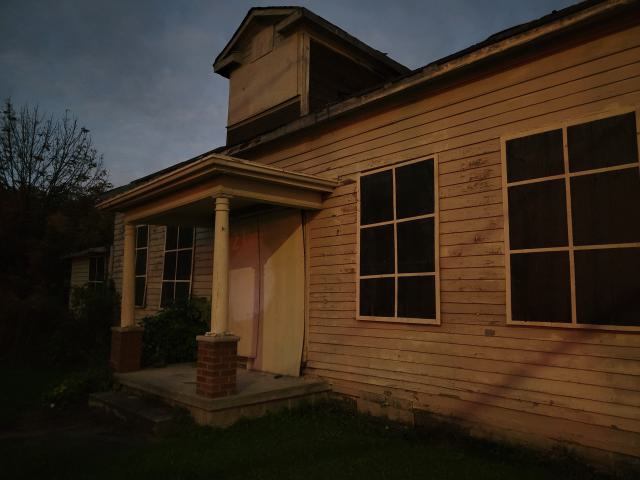 The front is boarded with fake windows