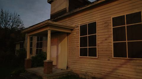 The front is boarded with fake windows